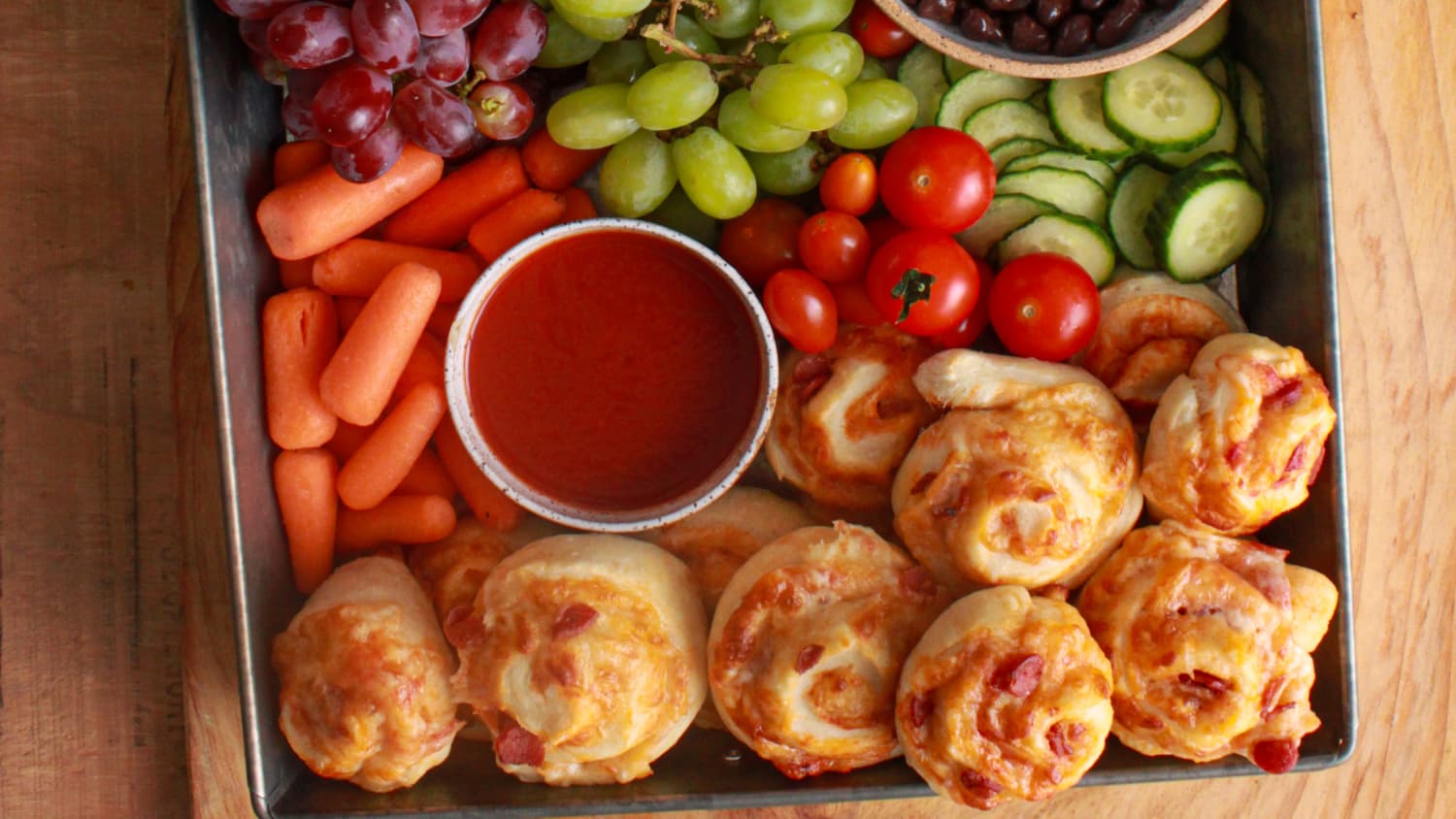 Family snack boards with fruits, veggies, and chips