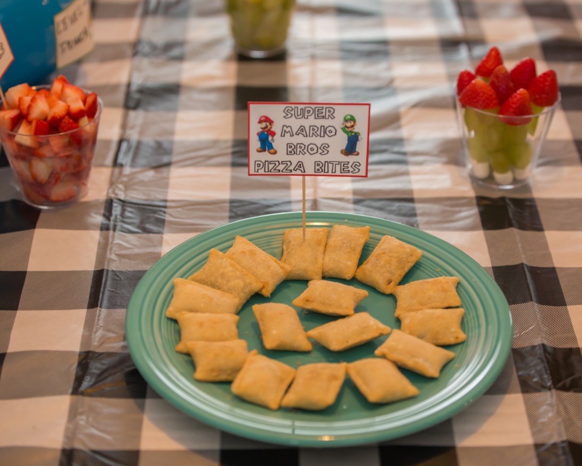 Friends playing Mario Party with snacks on the table